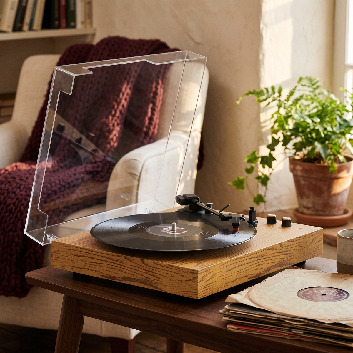 A three-speed turntable in a reading corner with a stack of old records